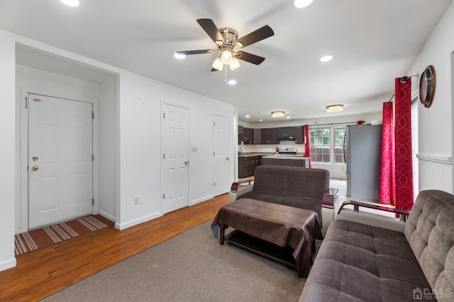 living room with hardwood / wood-style floors and ceiling fan