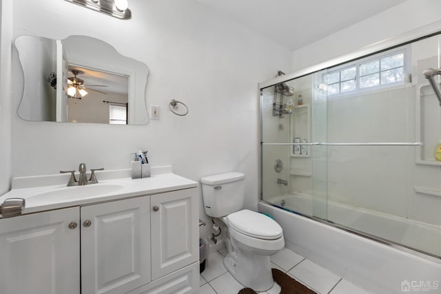 full bathroom with vanity, tile patterned floors, ceiling fan, toilet, and enclosed tub / shower combo