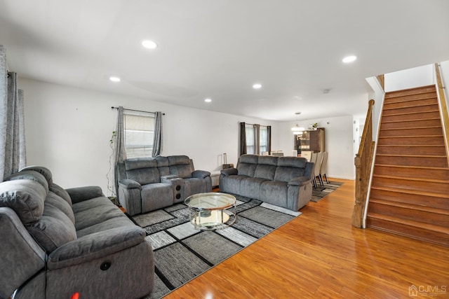 living area featuring stairs, recessed lighting, a wealth of natural light, and light wood-style floors