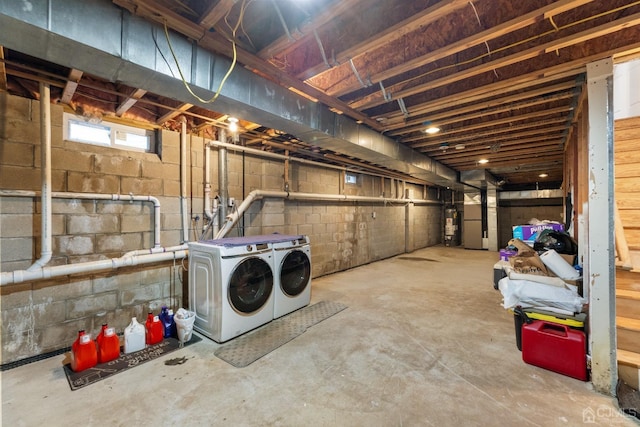 basement with gas water heater and washing machine and dryer