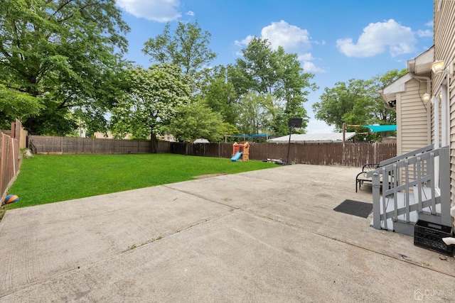 view of patio / terrace with a fenced backyard and a playground