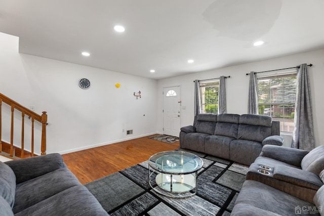 living room featuring recessed lighting, wood finished floors, visible vents, baseboards, and stairs