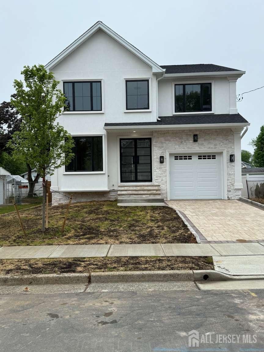 view of front of home featuring a garage, stucco siding, fence, decorative driveway, and entry steps