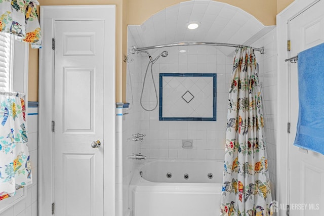 bathroom with a combined bath / shower with jetted tub