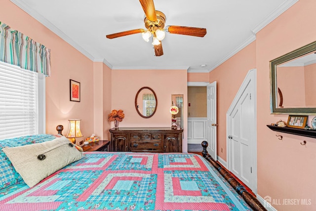 bedroom featuring ornamental molding, wood finished floors, and ceiling fan