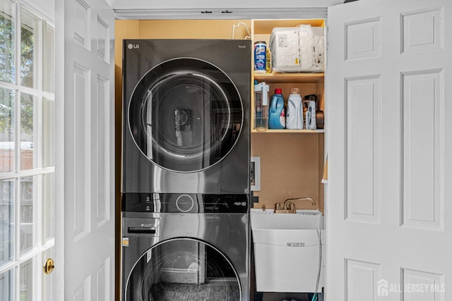 laundry area with stacked washer / dryer