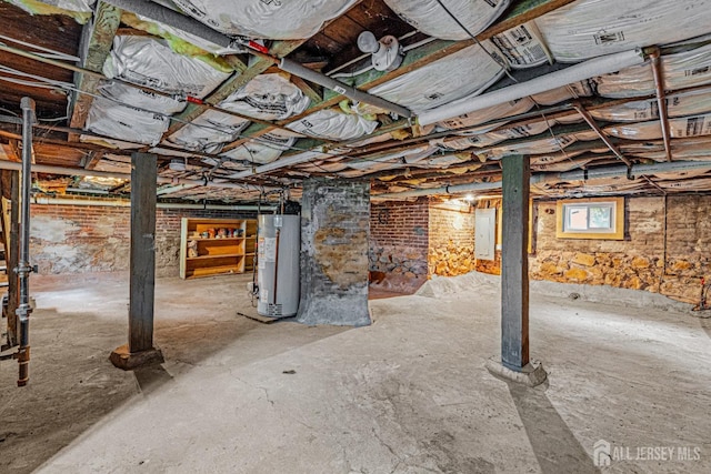 below grade area featuring gas water heater and electric panel