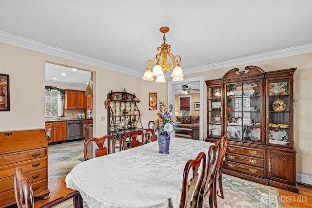 dining area with a chandelier, ornamental molding, light wood-type flooring, and ceiling fan
