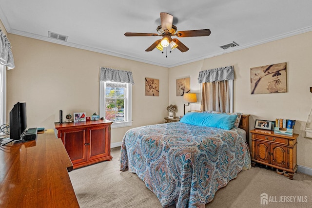 carpeted bedroom with crown molding, baseboards, and a ceiling fan