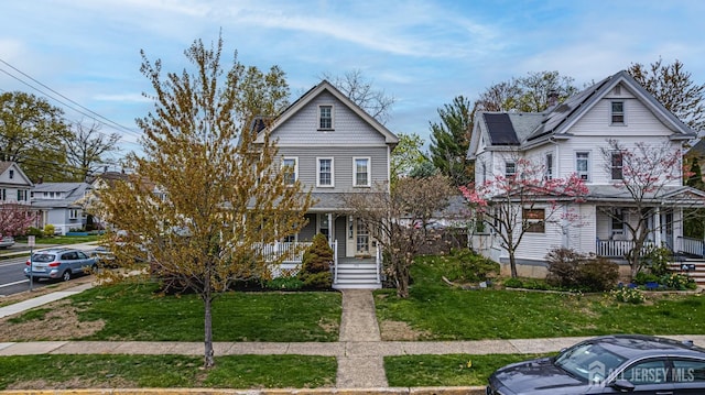 view of front of house with covered porch and a front yard