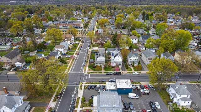 aerial view of property and surrounding area featuring nearby suburban area