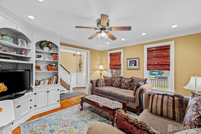 living room with light wood-style floors, ceiling fan, ornamental molding, recessed lighting, and stairway