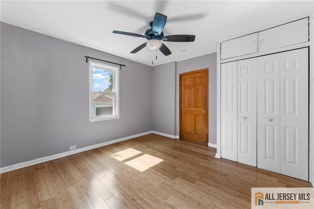 74 Charles St, Carteret, NJ 07008 - unfurnished bedroom featuring light wood-style floors, baseboards, a closet, and a ceiling fan