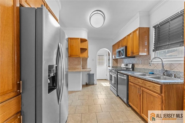 74 Charles St, Carteret, NJ 07008 - kitchen featuring stainless steel appliances, radiator heating unit, open shelves, crown molding, and decorative backsplash