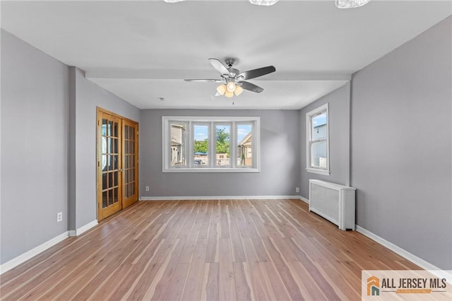 74 Charles St, Carteret, NJ 07008 - unfurnished room featuring radiator heating unit, light wood-type flooring, and baseboards