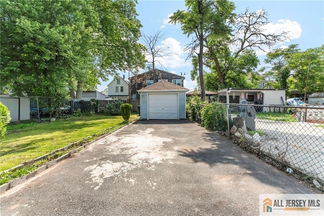 74 Charles St, Carteret, NJ 07008 - view of front of home with asphalt driveway and a detached garage