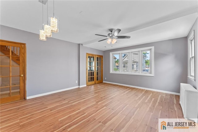 74 Charles St, Carteret, NJ 07008 - empty room with plenty of natural light, light wood-style floors, ceiling fan, and a chandelier
