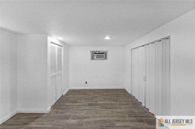 74 Charles St, Carteret, NJ 07008 - below grade area with a wall unit AC, wood finished floors, recessed lighting, and baseboards