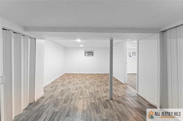 74 Charles St, Carteret, NJ 07008 - finished below grade area featuring wood finished floors, a wall unit AC, baseboards, and recessed lighting