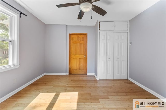 74 Charles St, Carteret, NJ 07008 - unfurnished bedroom featuring light wood-type flooring, baseboards, and a closet