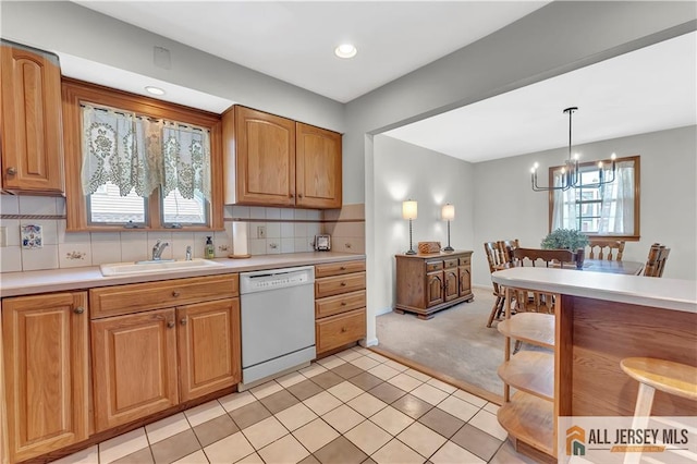 323 Green St, Woodbridge Proper, NJ 07095 - kitchen with white dishwasher, a chandelier, light countertops, pendant lighting, and light carpet