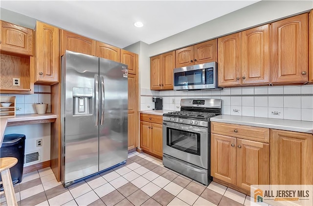 323 Green St, Woodbridge Proper, NJ 07095 - kitchen featuring stainless steel appliances, light countertops, tasteful backsplash, and light tile patterned floors