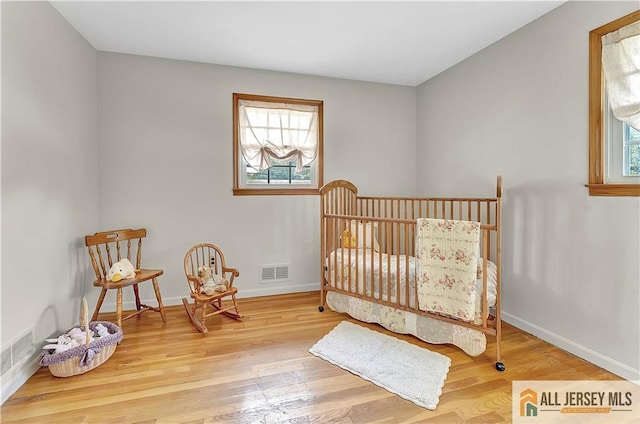 323 Green St, Woodbridge Proper, NJ 07095 - bedroom with wood finished floors and a nursery area
