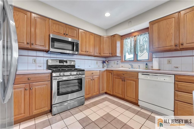 323 Green St, Woodbridge Proper, NJ 07095 - kitchen with stainless steel appliances, light countertops, light tile patterned floors, backsplash, and recessed lighting