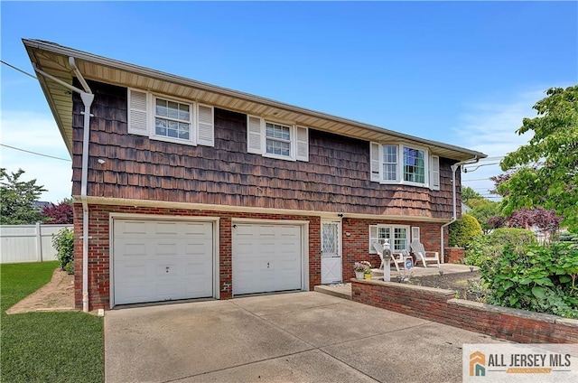323 Green St, Woodbridge Proper, NJ 07095 - view of front of home with an attached garage, driveway, and brick siding