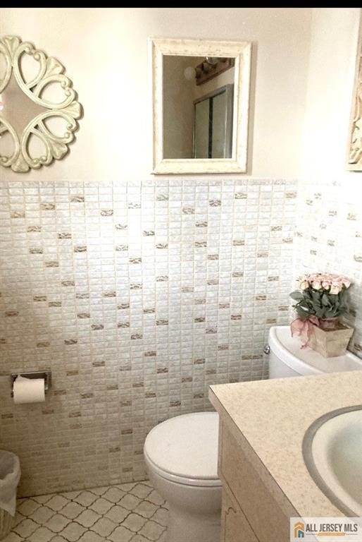 323 Green St, Woodbridge Proper, NJ 07095 - half bathroom with vanity, tile patterned flooring, and tile walls