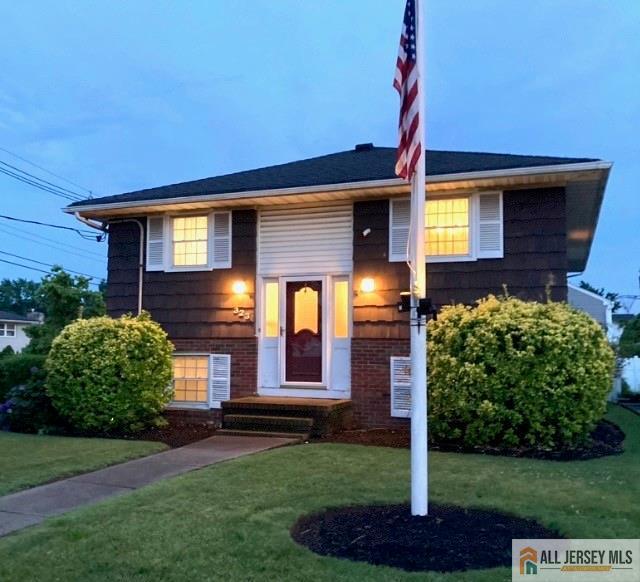 323 Green St, Woodbridge Proper, NJ 07095 - split foyer home featuring brick siding and a front yard