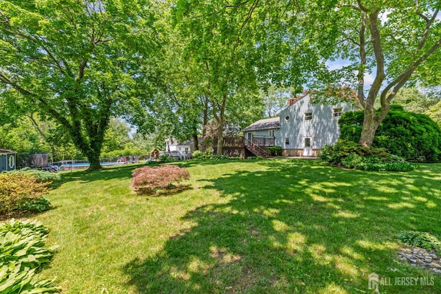 41 Winton Rd, East Brunswick, NJ 08816 - view of green lawn with stairs, an outdoor pool, and a deck
