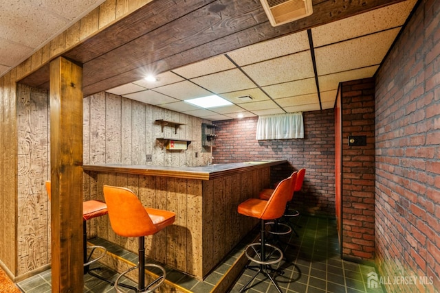 41 Winton Rd, East Brunswick, NJ 08816 - indoor dry bar with a drop ceiling, tile patterned flooring, and brick wall