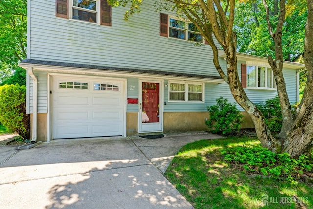 41 Winton Rd, East Brunswick, NJ 08816 - view of front facade with an attached garage and driveway