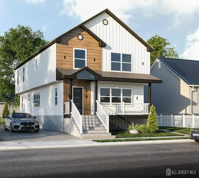 view of front facade featuring metal roof, a porch, and board and batten siding