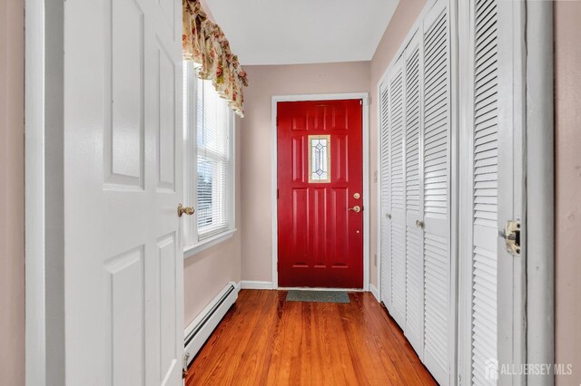 doorway featuring a baseboard radiator and hardwood / wood-style floors