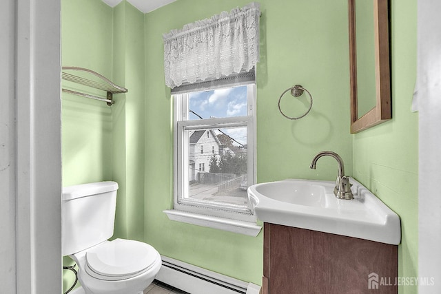 bathroom with baseboard heating, vanity, and toilet