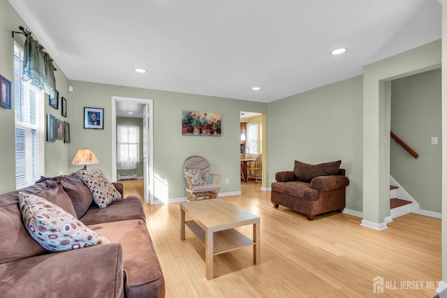 living room featuring a baseboard heating unit and light wood-type flooring