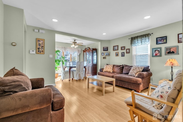 living room with ceiling fan and light hardwood / wood-style floors