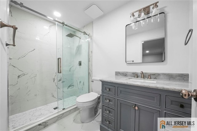 full bath with a marble finish shower, toilet, marble finish floor, and vanity