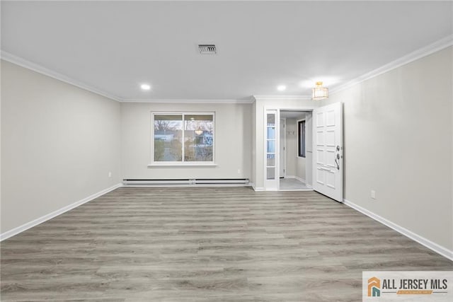 unfurnished room featuring ornamental molding, light hardwood / wood-style floors, and baseboard heating