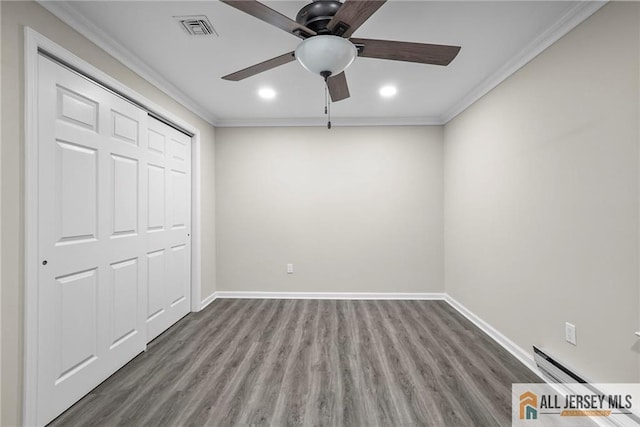 unfurnished bedroom featuring ceiling fan, a baseboard radiator, ornamental molding, and wood-type flooring