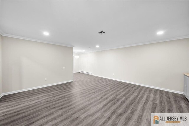 interior space featuring a baseboard heating unit, ornamental molding, and dark hardwood / wood-style floors