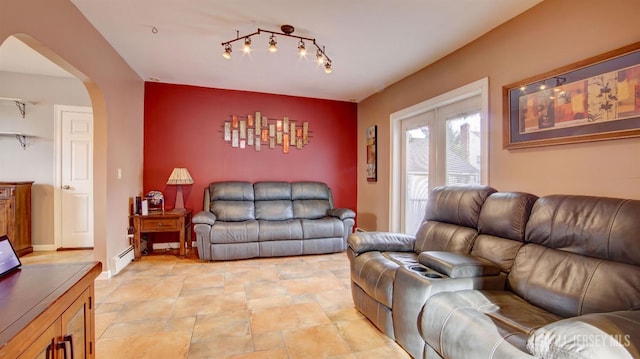 living room featuring track lighting and a baseboard heating unit