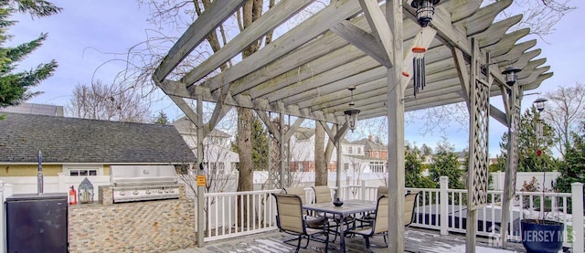 view of patio / terrace featuring a grill, a pergola, and an outdoor kitchen