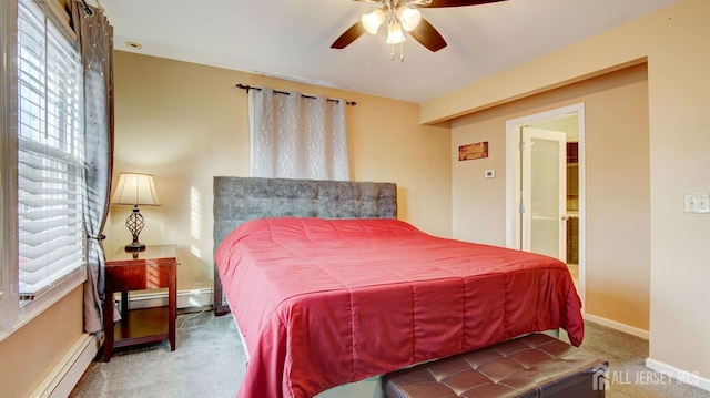 carpeted bedroom featuring a baseboard radiator and ceiling fan