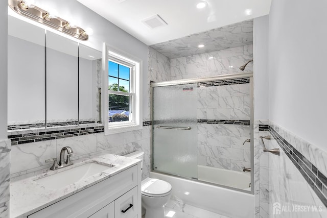 65 Bayview St, Aberdeen, NJ 07721 - bathroom with tile walls, vanity, marble finish flooring, combined bath / shower with glass door, and recessed lighting