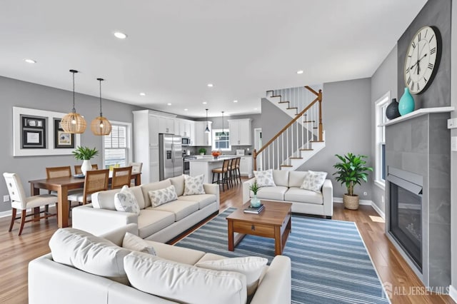 65 Bayview St, Aberdeen, NJ 07721 - living area with stairs, a glass covered fireplace, light wood-style flooring, and recessed lighting