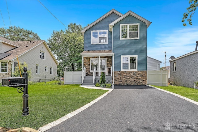 65 Bayview St, Aberdeen, NJ 07721 - view of front of house with stone siding and a porch