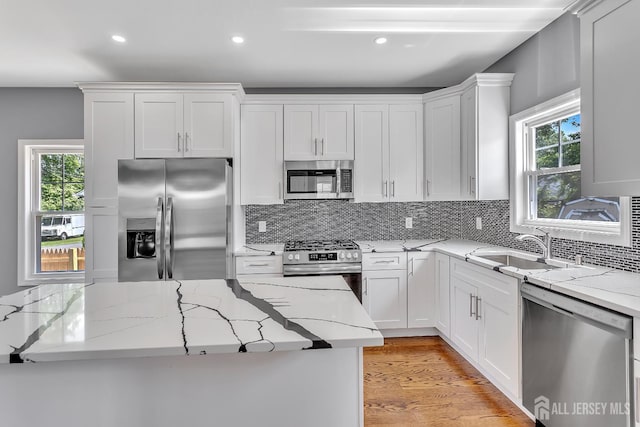 65 Bayview St, Aberdeen, NJ 07721 - kitchen featuring appliances with stainless steel finishes, recessed lighting, healthy amount of natural light, and backsplash